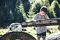 Boy playing with a water wheel at the head of the valley in Saalbach Hinterglemm