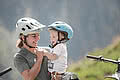 Lady and small child standing next to a bicycle trailer